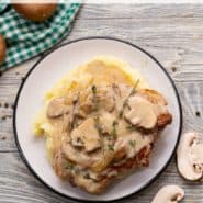 Pork on a plate, text overlay reads, "smothered pork chops, rachelcooks.com"