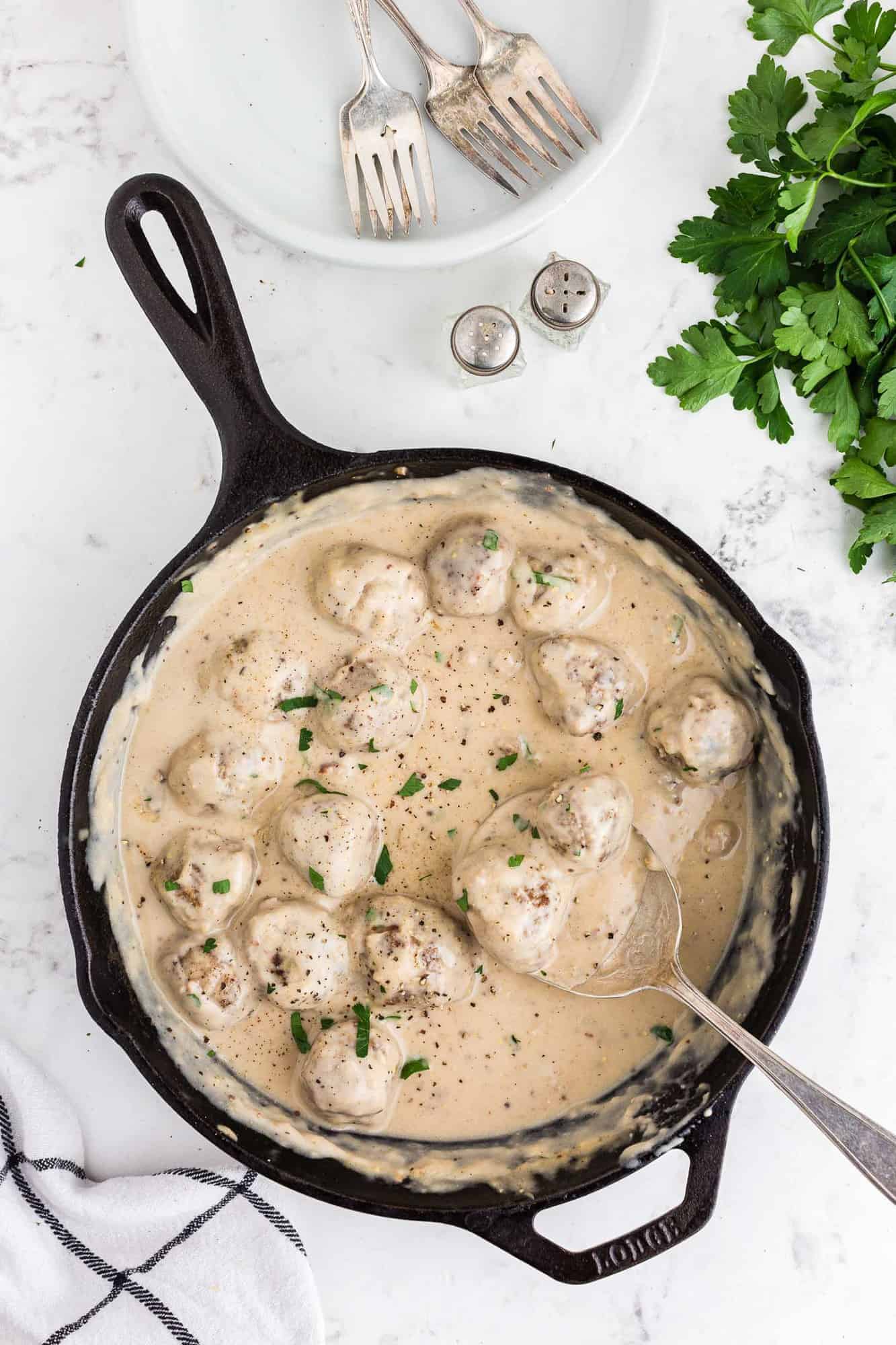 Swedish meatballs in a black cast iron pan.