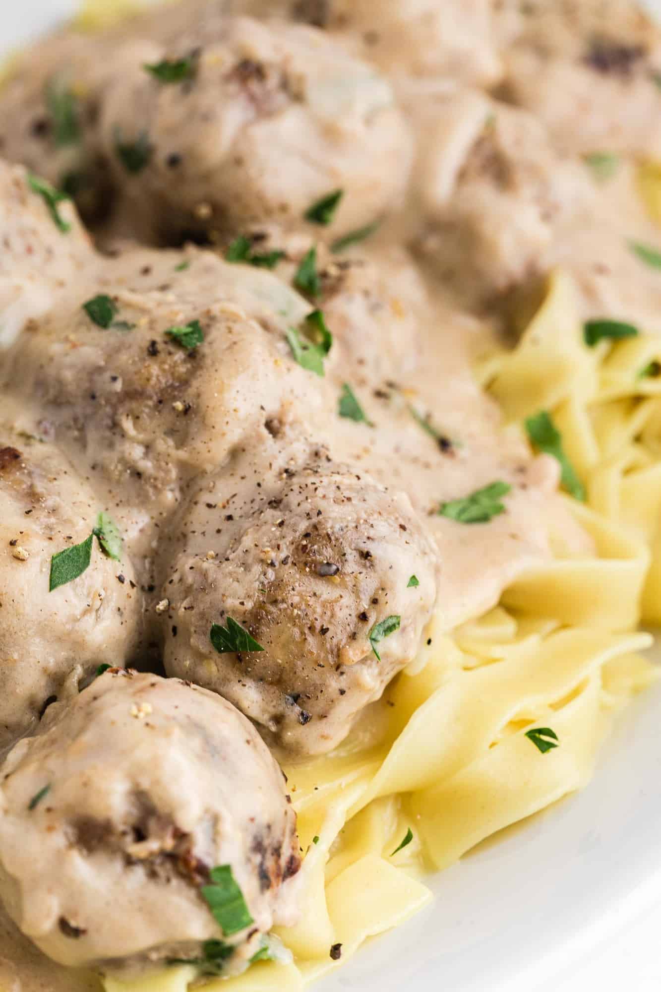 Creamy meatballs on noodles.