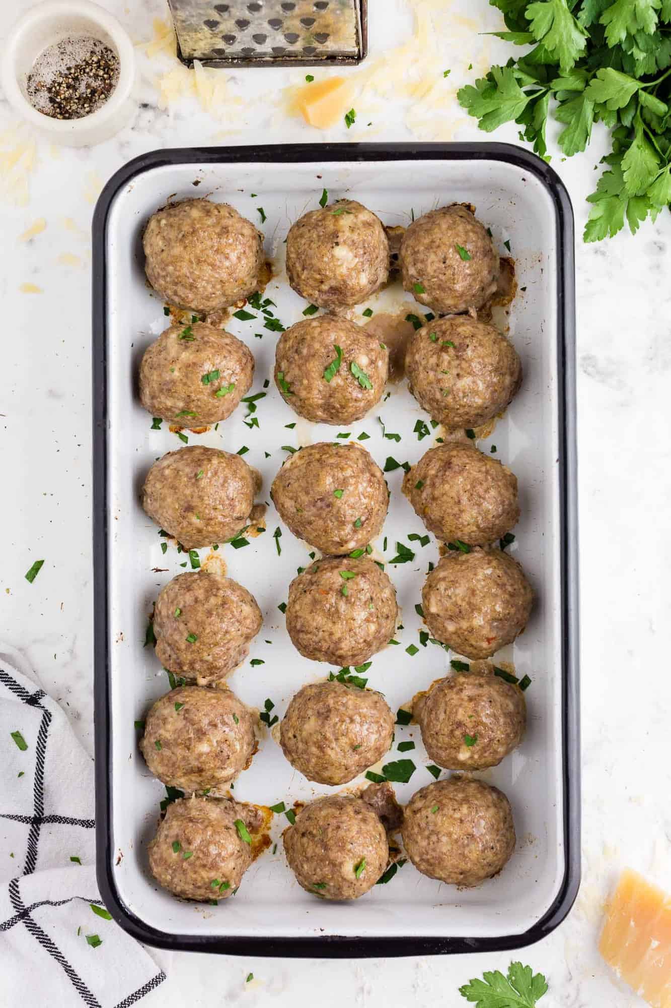 Cooked meatballs in a baking dish.