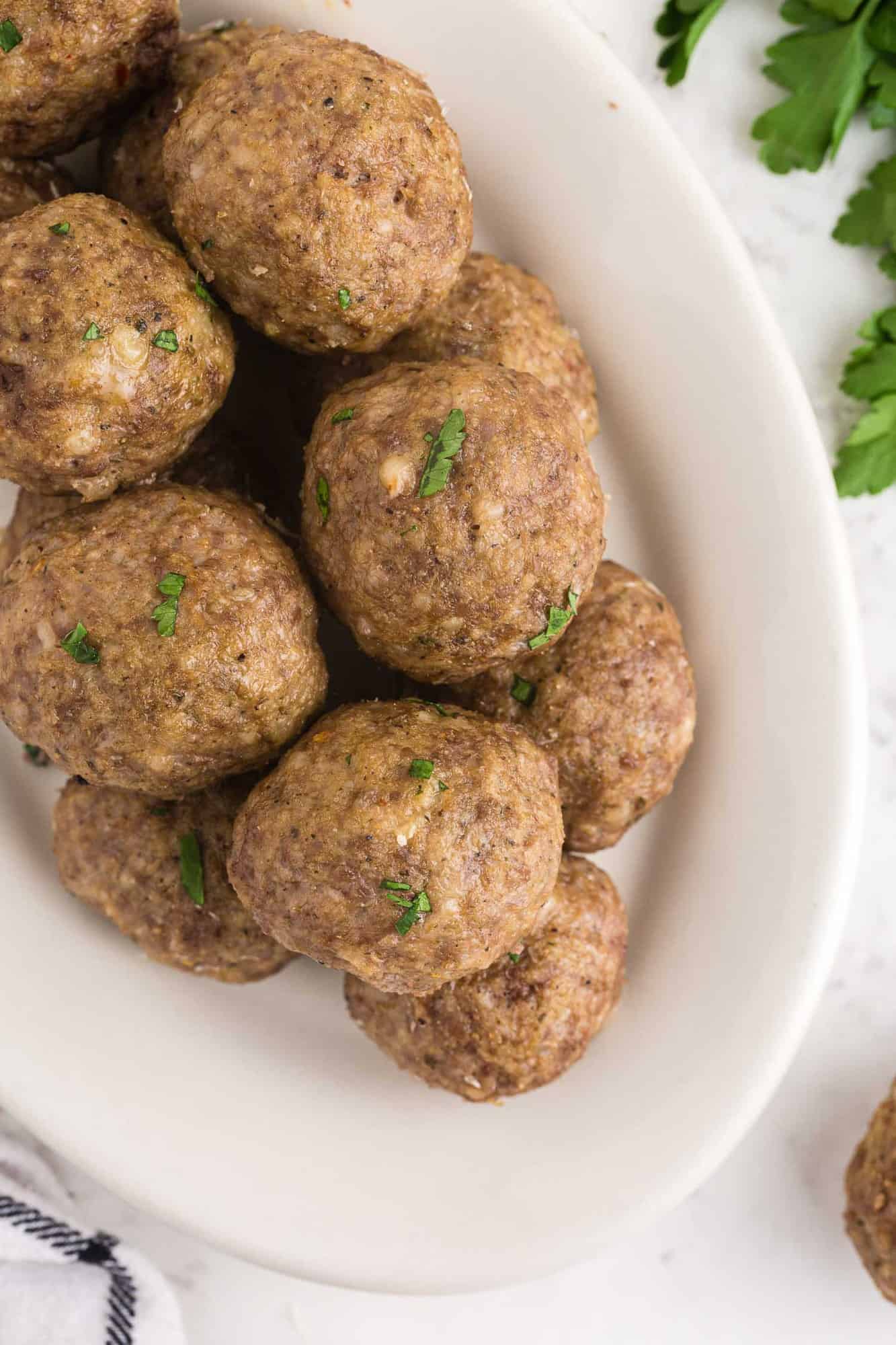 Cooked meatballs piled on a platter.