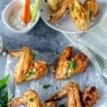Golden brown chicken wings topped with fresh parsley.