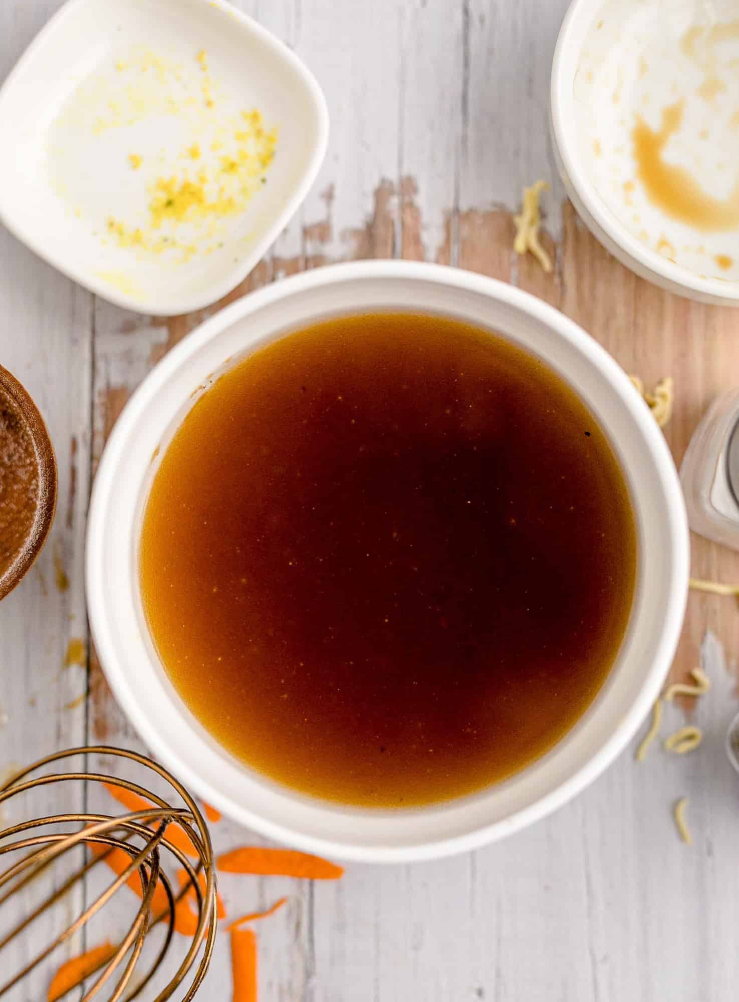 Brown dressing in a white bowl.