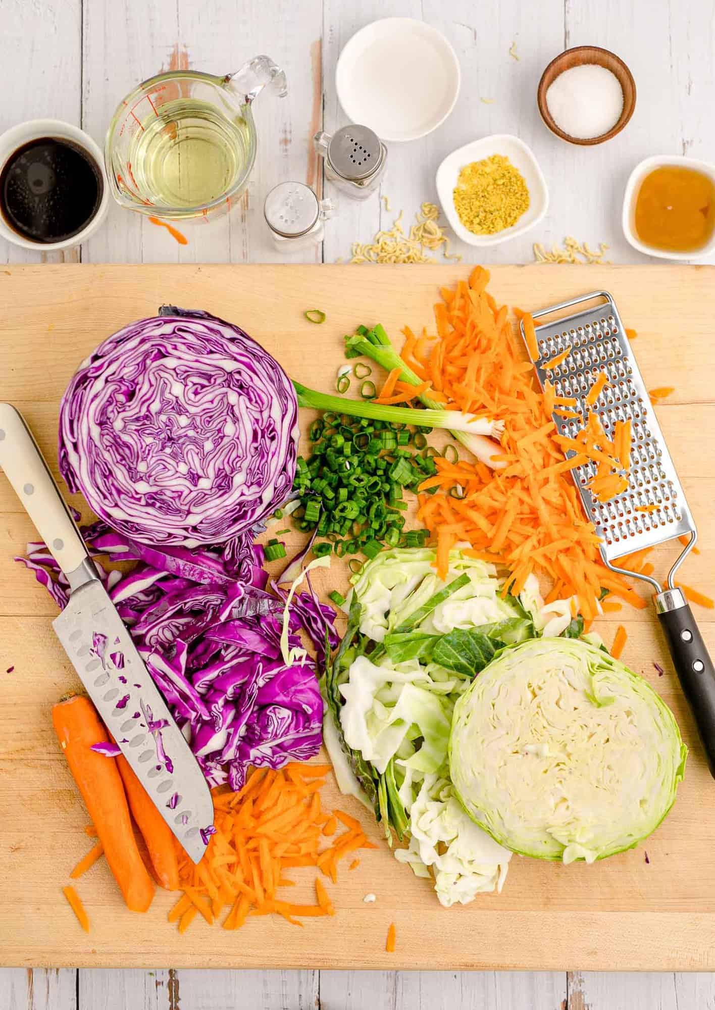 Shredded vegetables, a knife, and a grater.