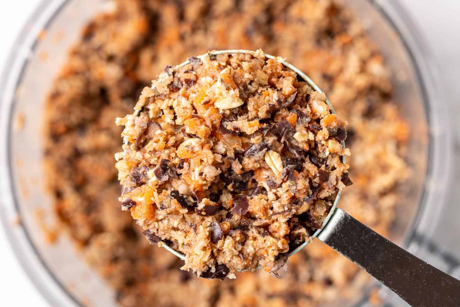 Unformed bean burger mixture in a measuring cup.