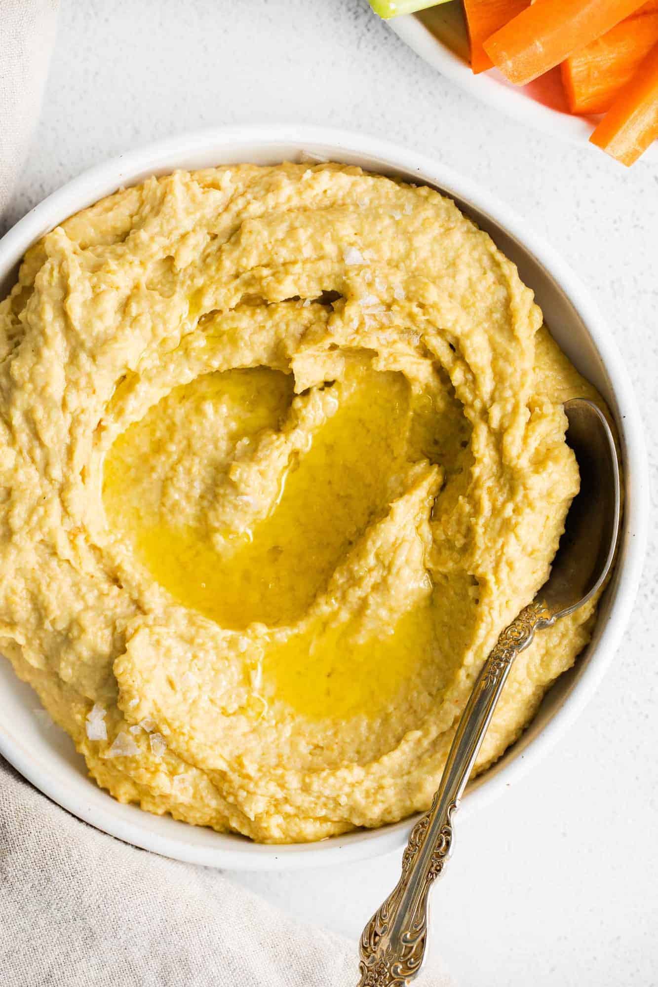 Hummus in a bowl topped with olive oil.