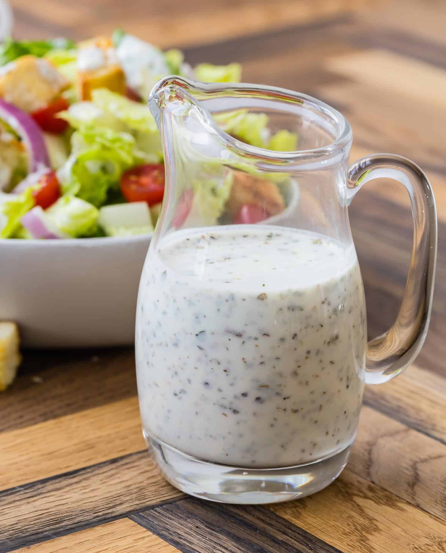 White dressing in a small glass pitcher.