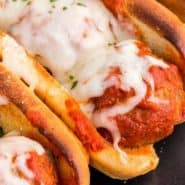 Cheesy meatballs in a bun, text overlay reads "the best meatball subs, rachelcooks.com"