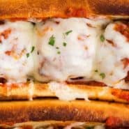 Cheesy meatballs in a bun, text overlay reads "the best meatball subs, rachelcooks.com"