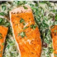 Overhead view of seared salmon, text overlay reads "salmon with spinach poblano cream sauce."