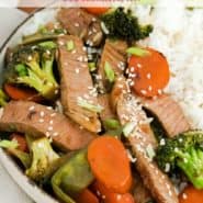 Beef and vegetables in a bowl, text overlay reads "easy sesame beef - perfect weeknight meal! rachelcooks.com"