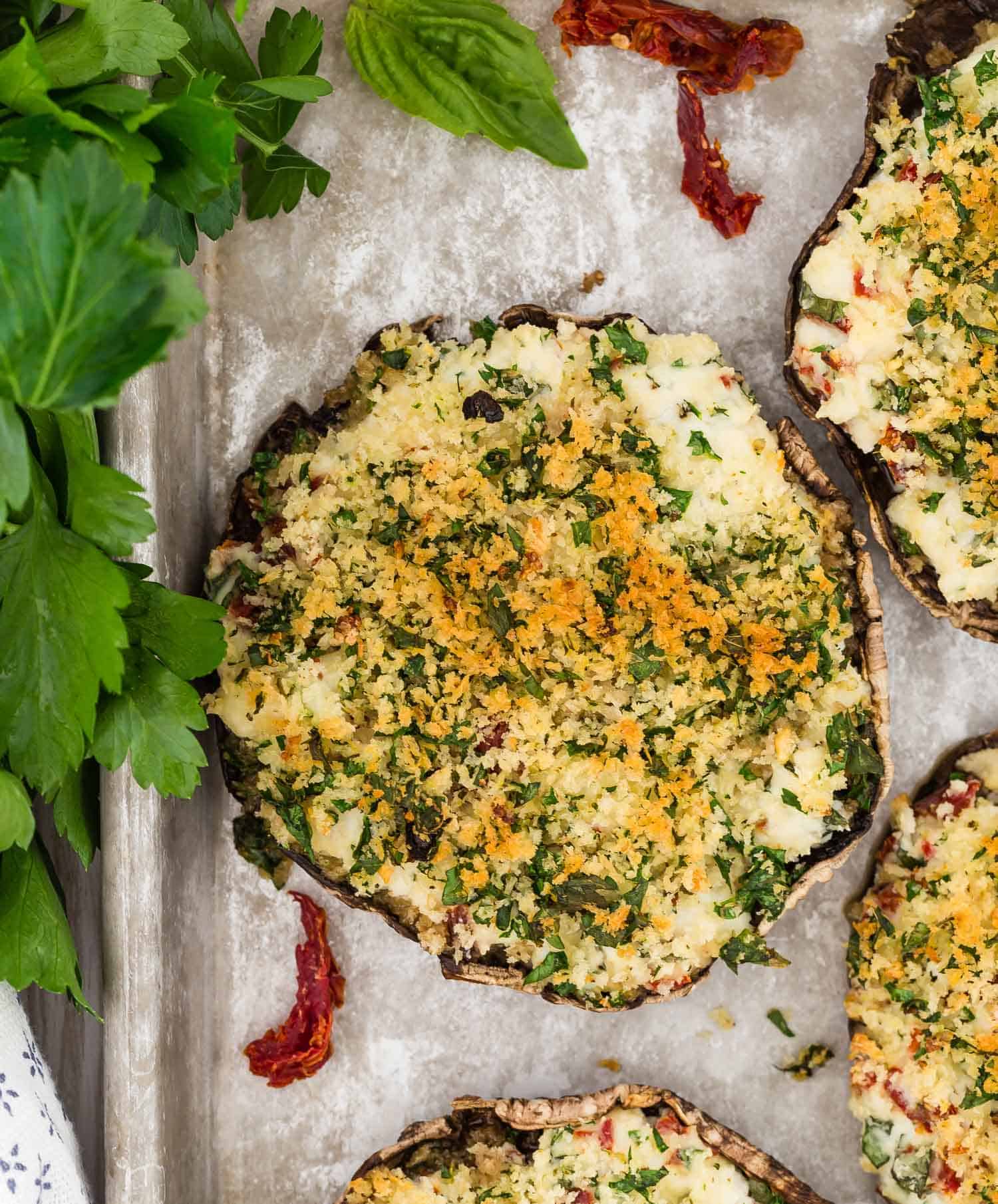 Overhead view of a cooked mushroom with filling and golden brown breadcrumb topping.