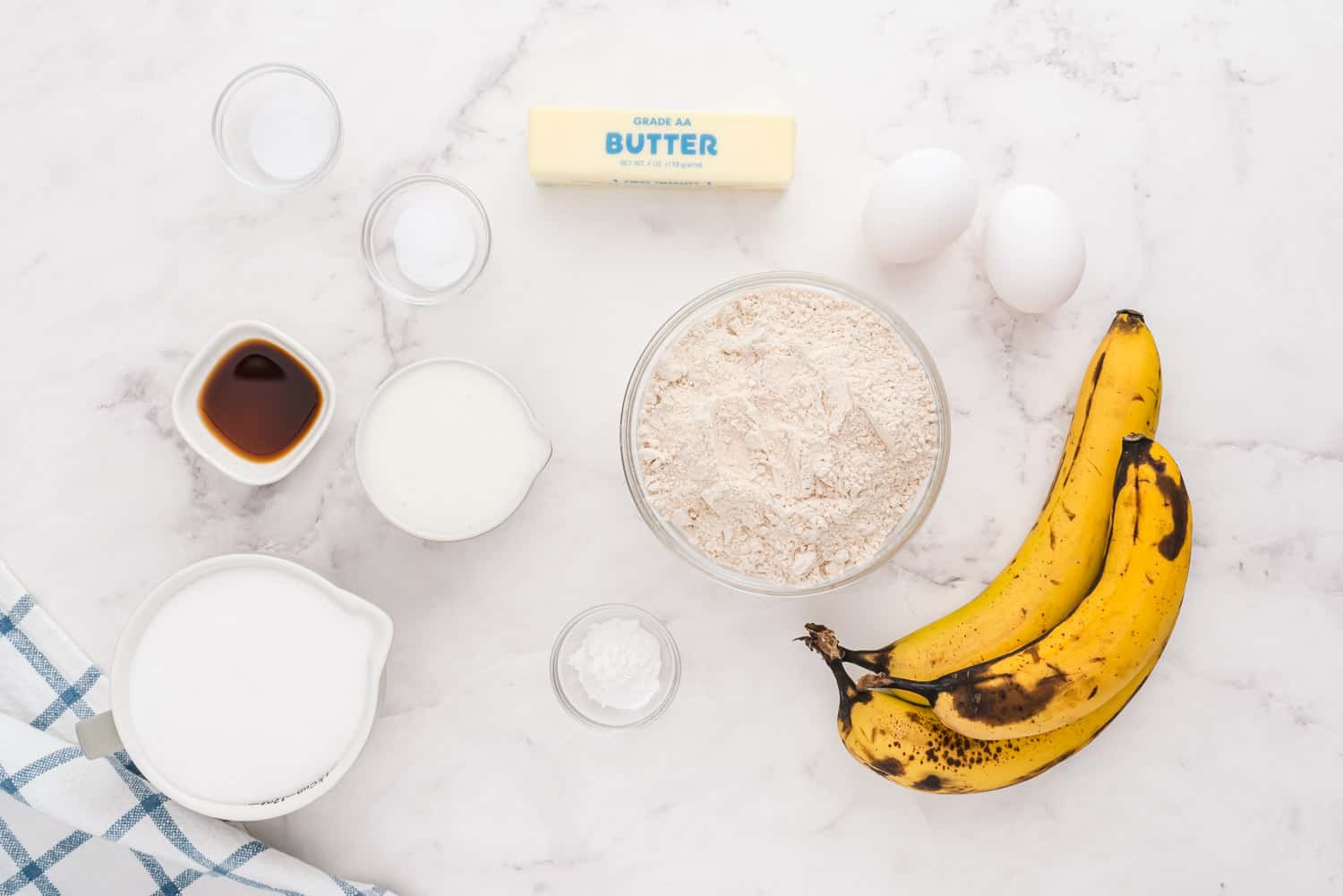 Overhead view of ingredients, including ripe bananas still in peels.