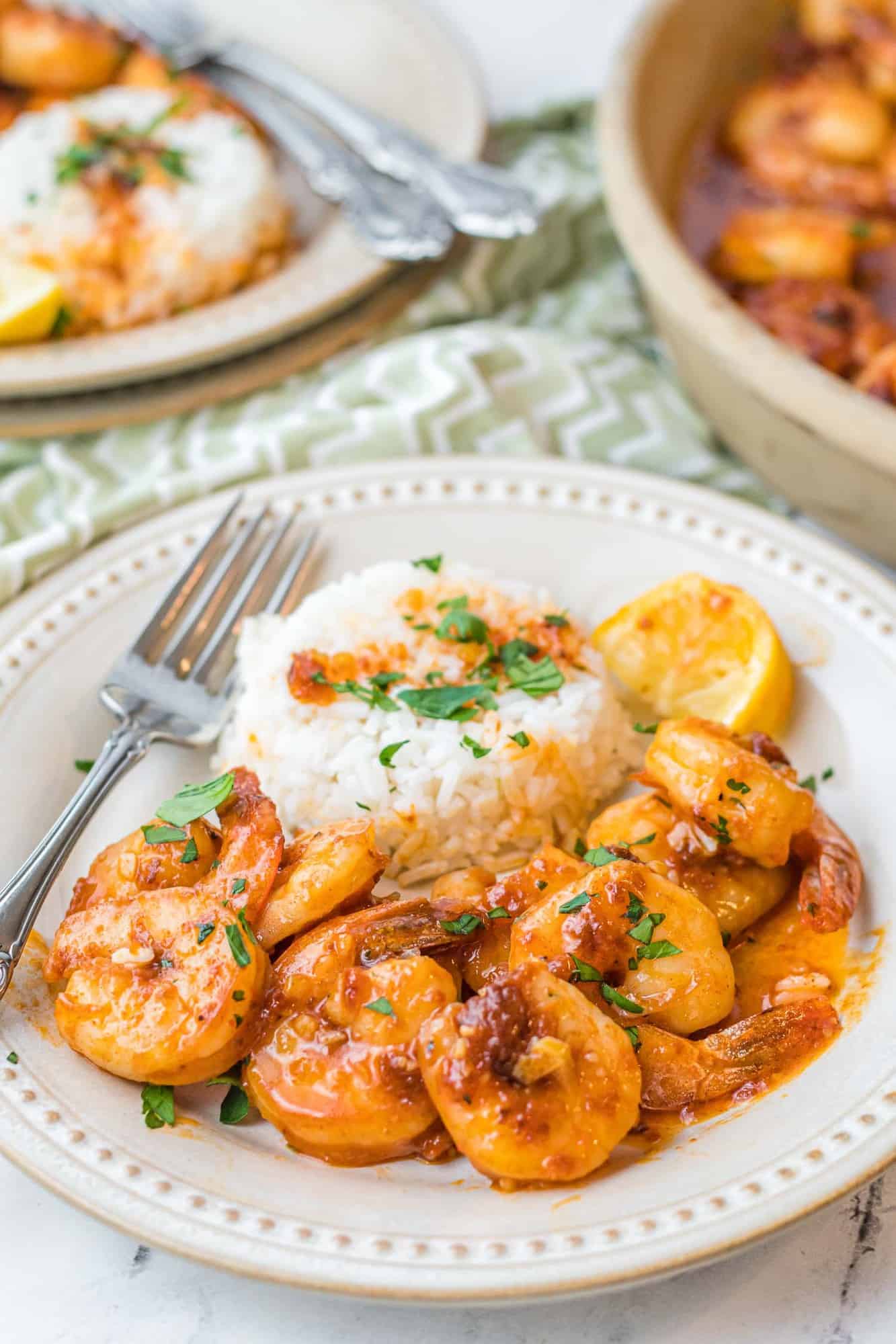 Shrimp in a honey garlic sauce on a plate with rice.