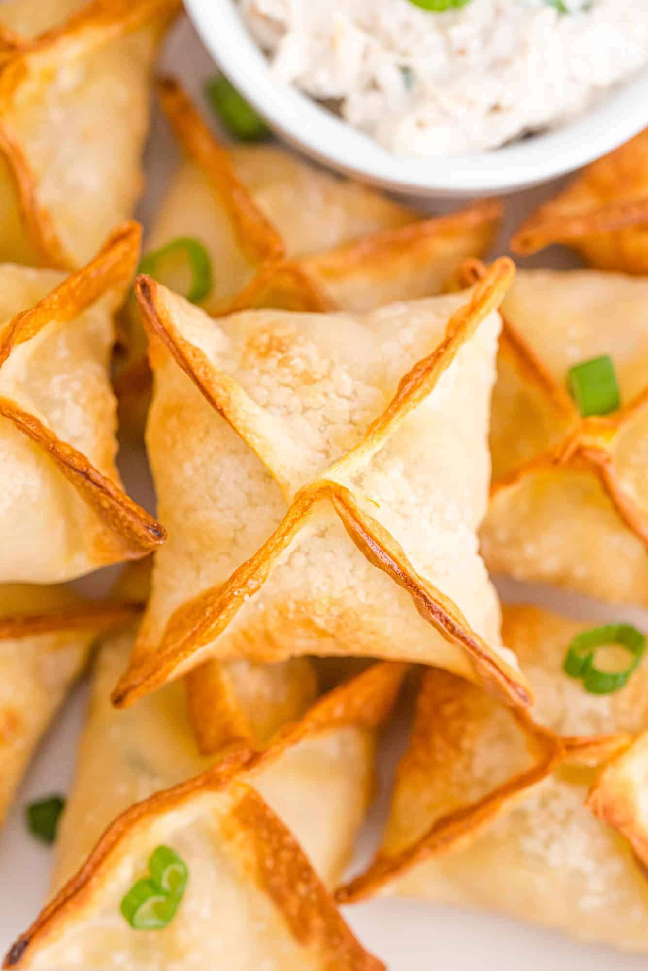 Stack of air fryer crab rangoon on a plate.