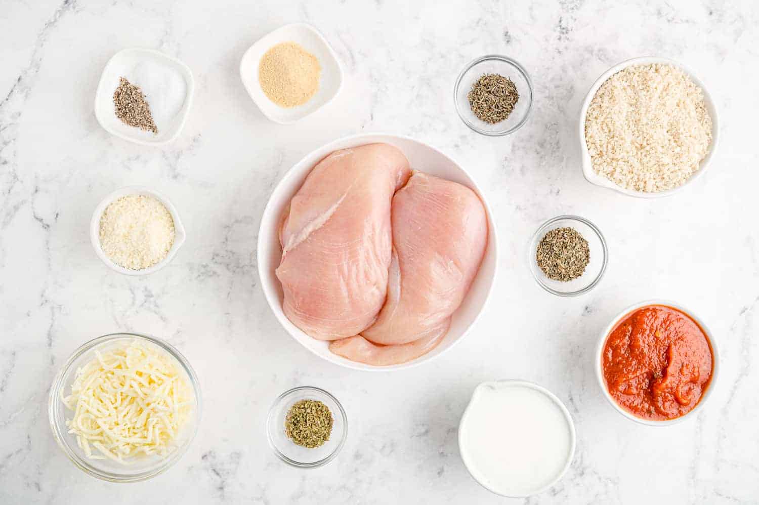 Overhead view of ingredients needed to make baked chicken parmesan.