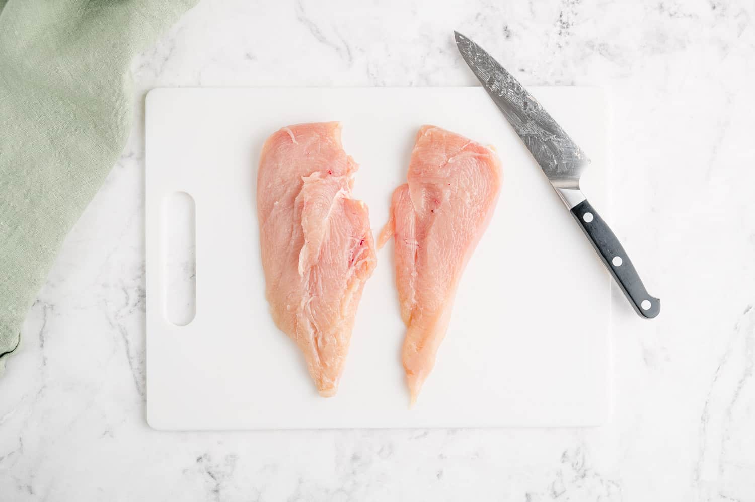 A chicken breast, cut in half to make thin cutlets.