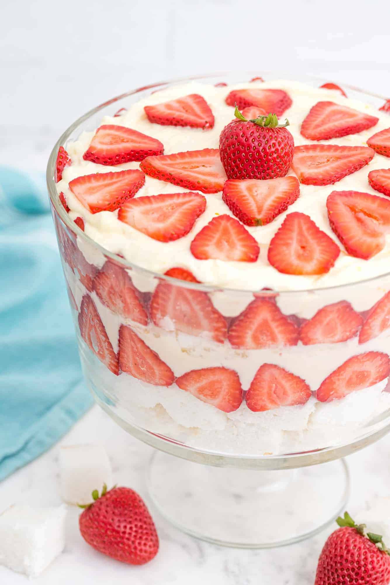 Trifle made with layers of strawberries, angel food cake, and pudding whipped cream mixture.