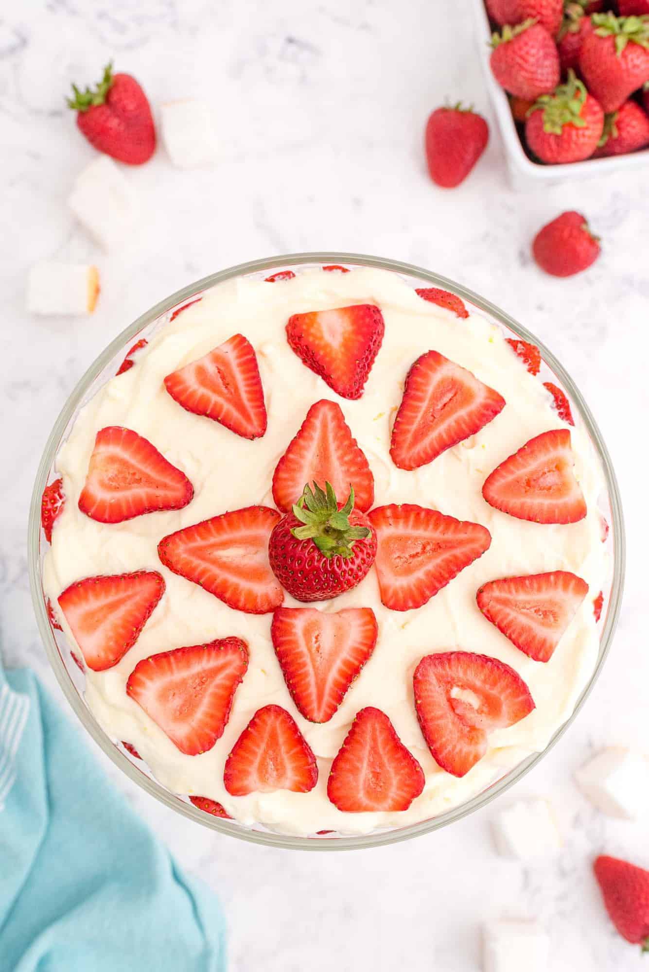 Strawberry dessert viewed from above, topped decoratively with slices of strawberries.