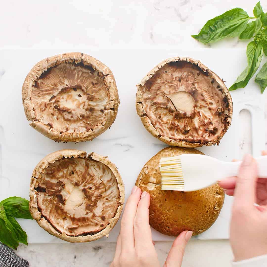 Mushroom being brushed with oil.