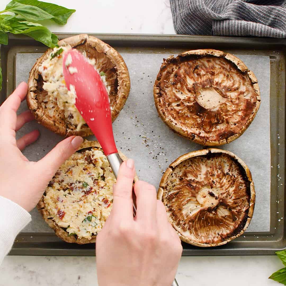 Filling being placed in mushrooms.