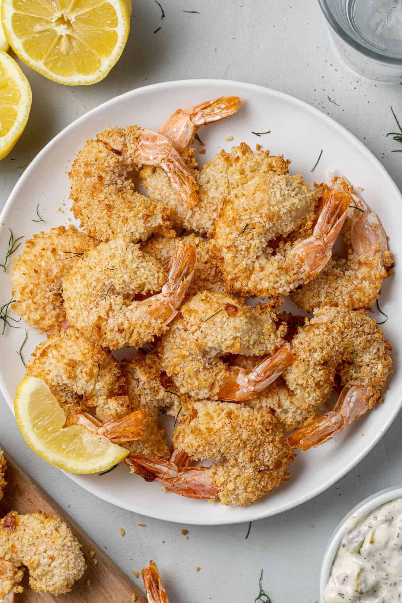 Cooked breaded shrimp piled on a plate.