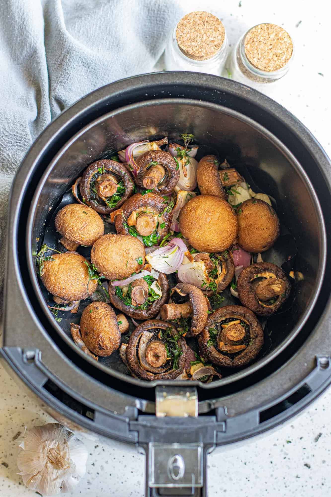 Cooked mushrooms in an air fryer.