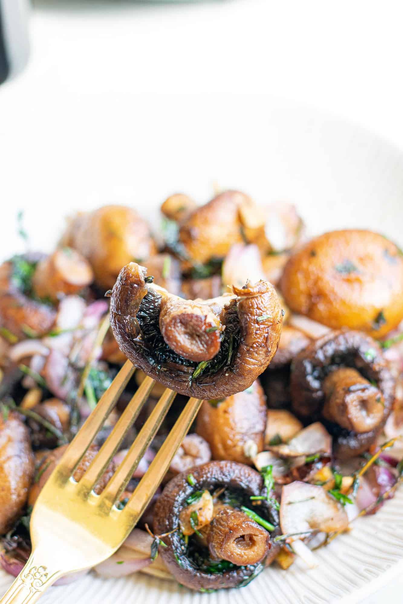 Mushroom on a fork with a bite out of it.