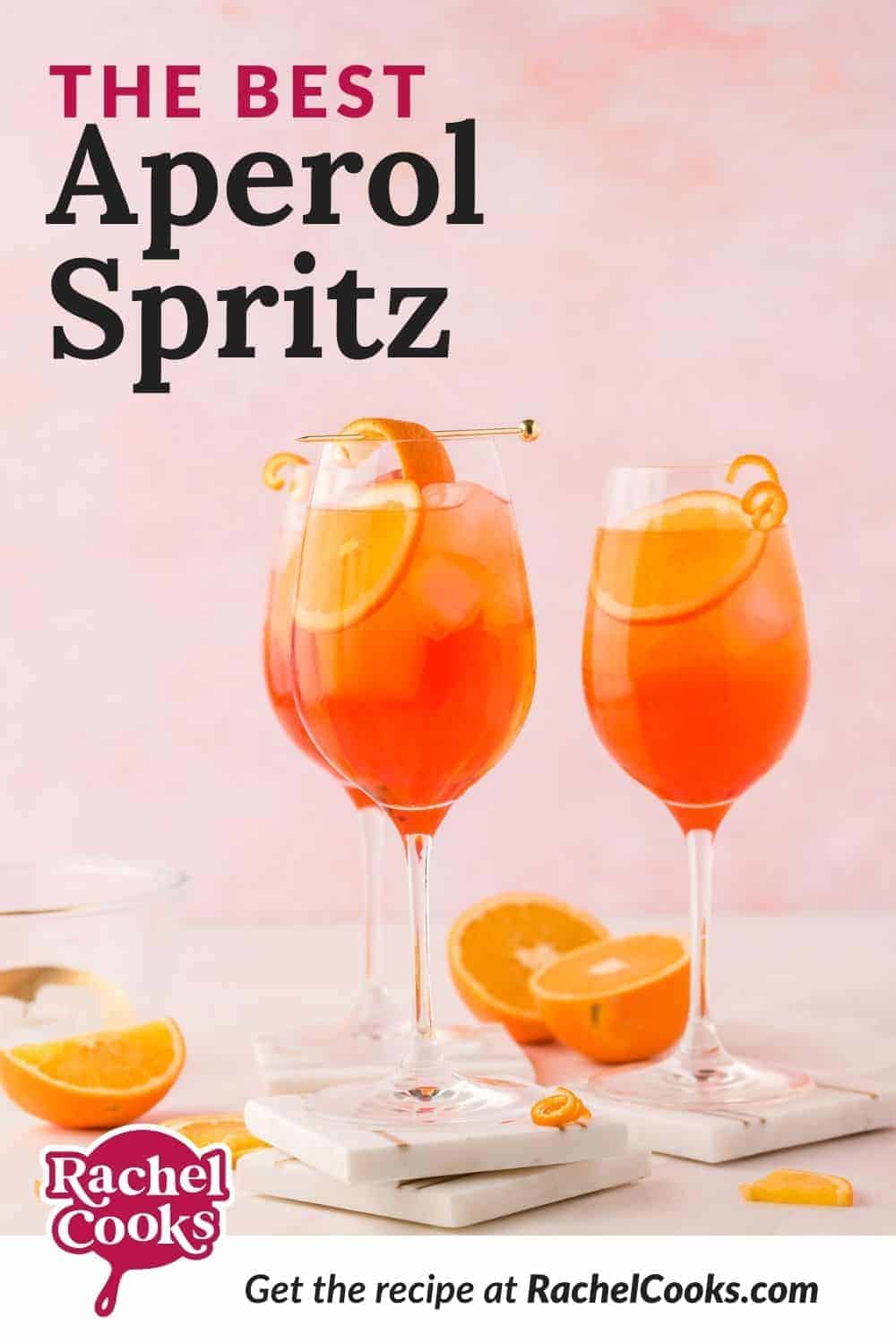 An orange drink in a wine glass, with a text overlay that reads "the best aperol spritz."