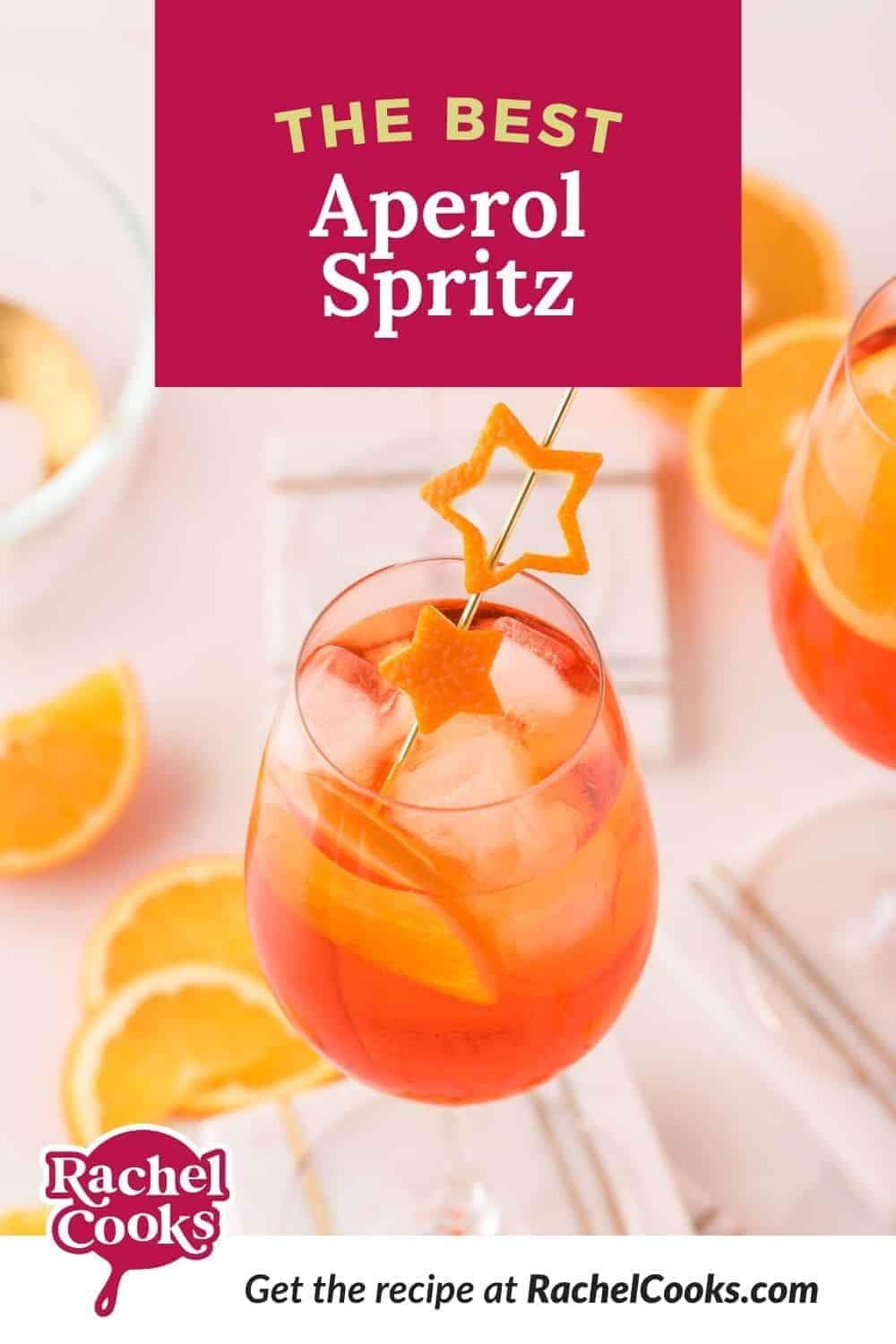 An orange drink in a wine glass, with a text overlay that reads "the best aperol spritz."
