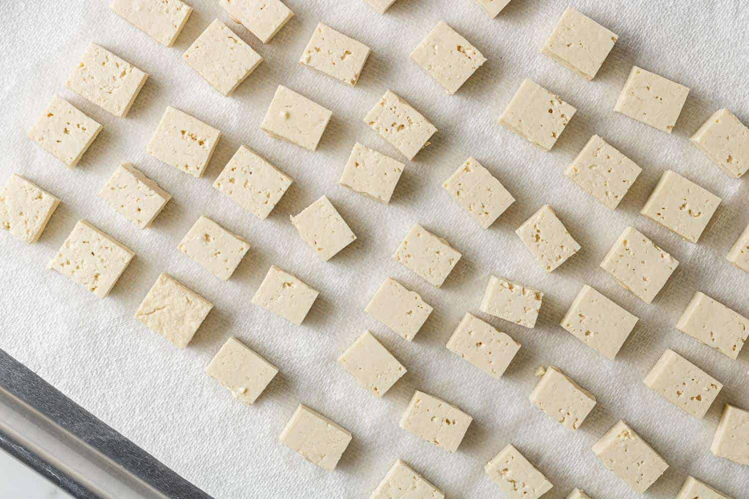 Cut tofu on paper towel lined baking sheet.
