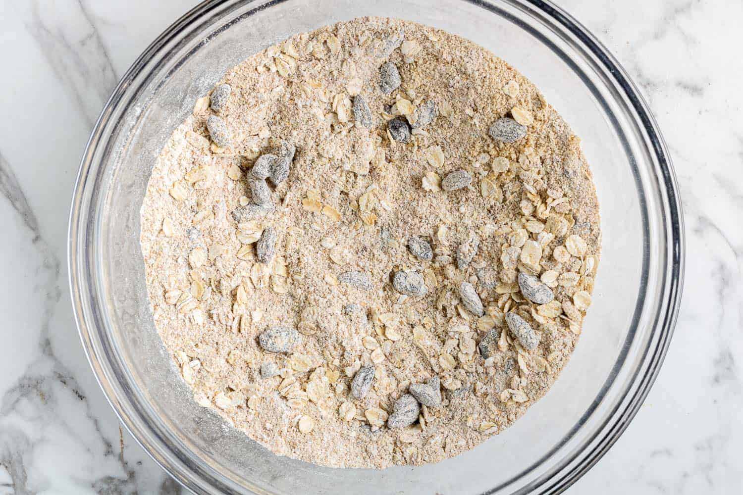 Dry ingredients in a clear glass mixing bowl.