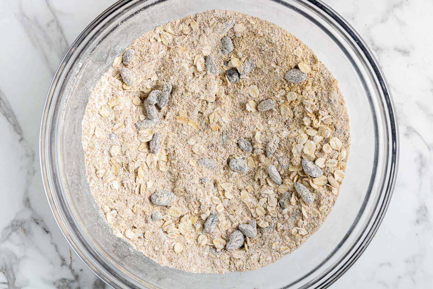 Dry ingredients in a clear glass mixing bowl.