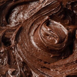 Close up of chocolate buttercream frosting, swirled to show texture.
