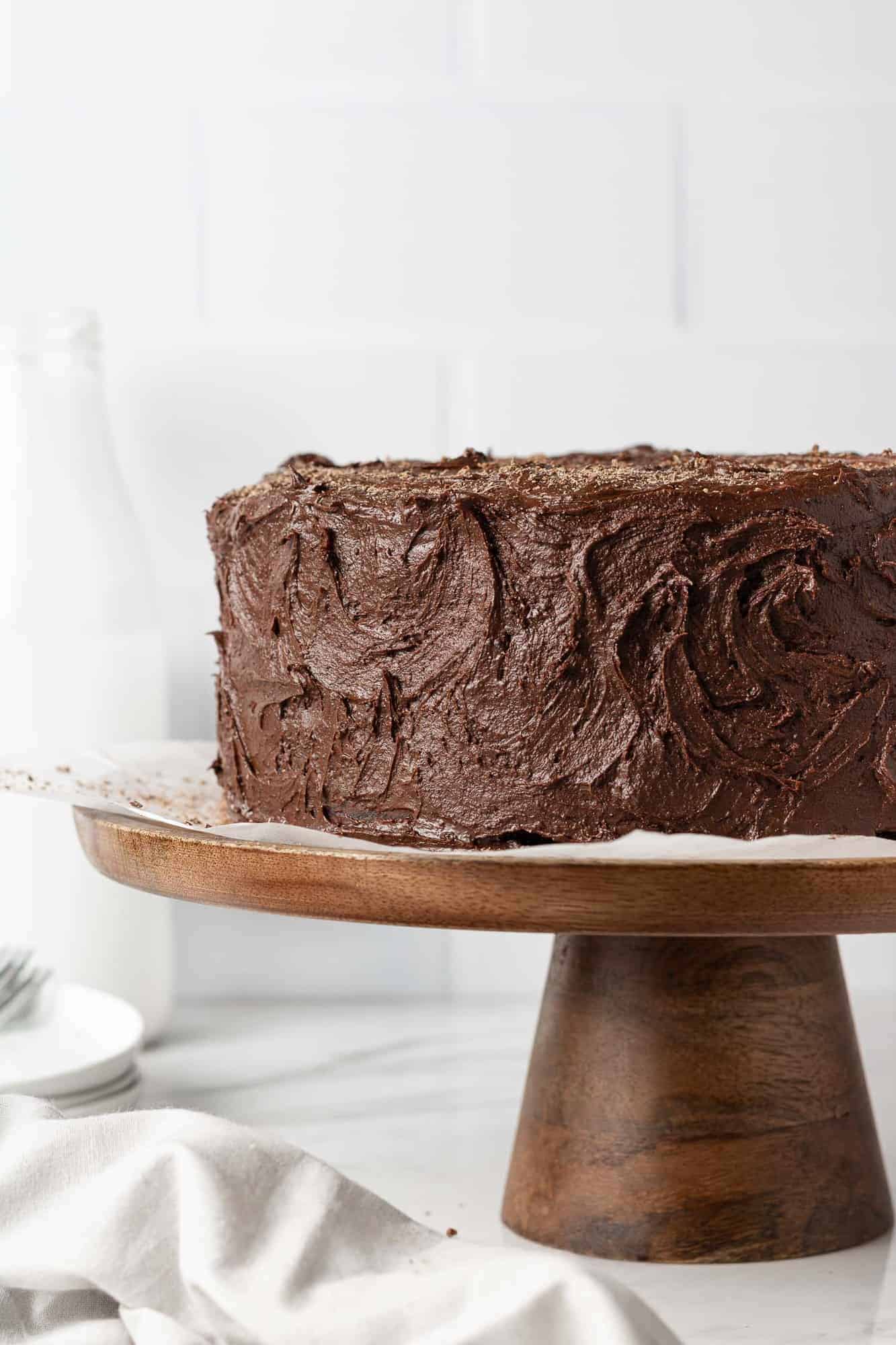 Chocolate layer cake on a cake stand.