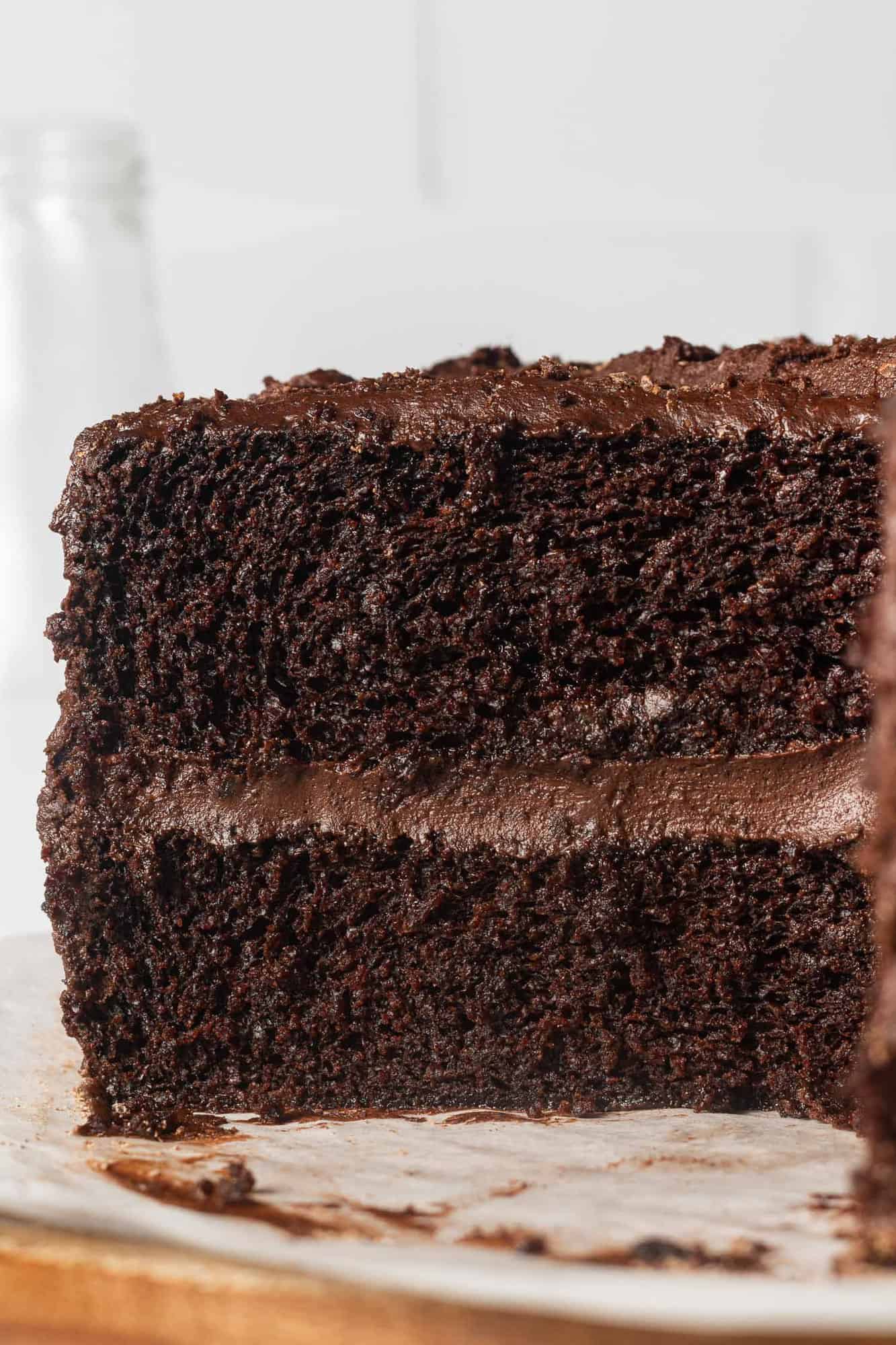 Chocolate layer cake, sliced, frosted with chocolate frosting.