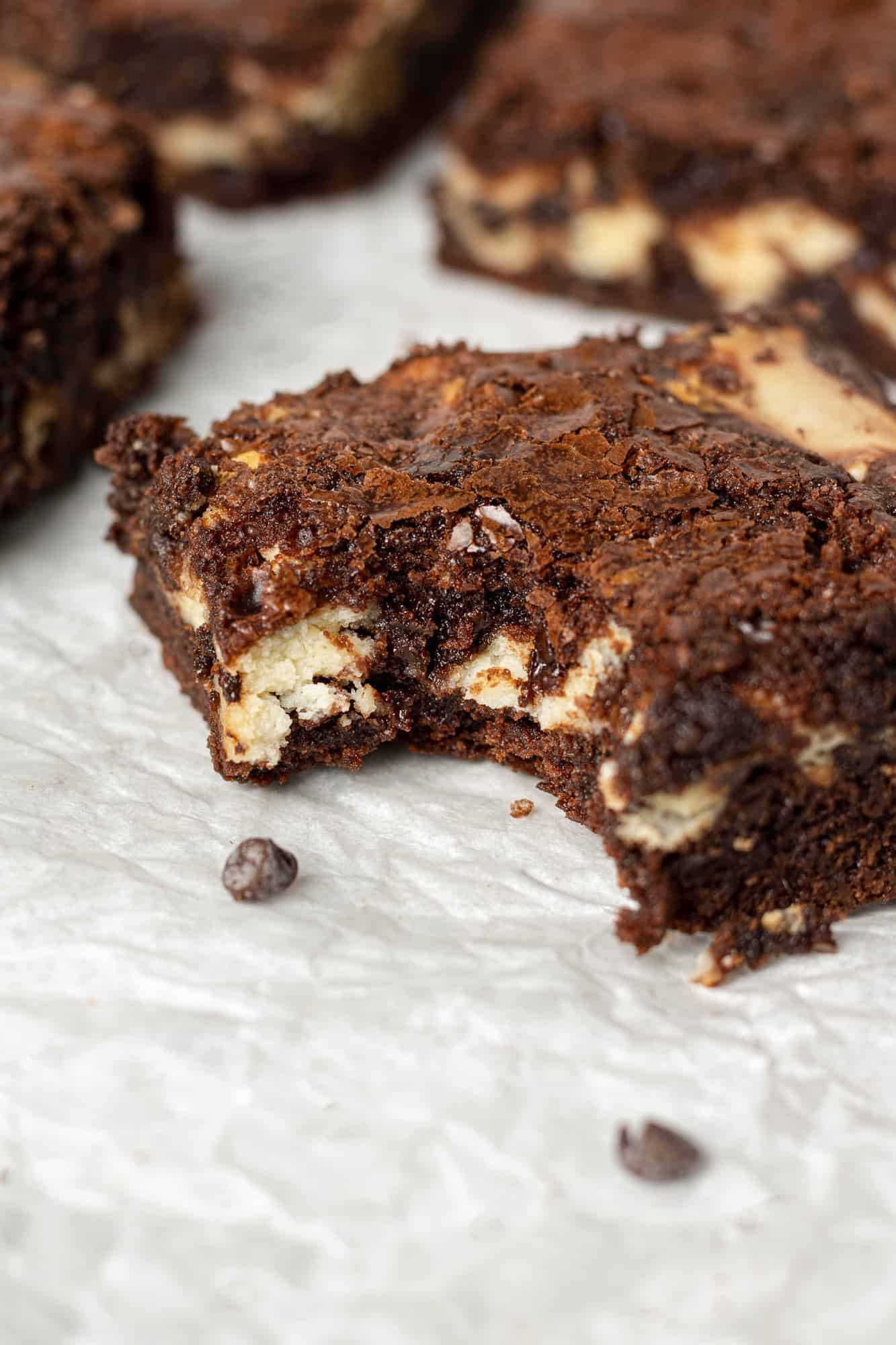 Brownie with a bite taken out of it, showing cream cheese filling.