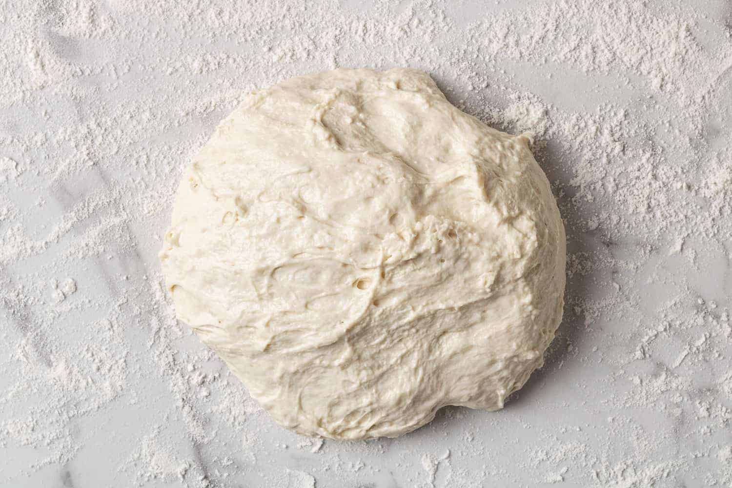 Ball of dough on a floured surface.
