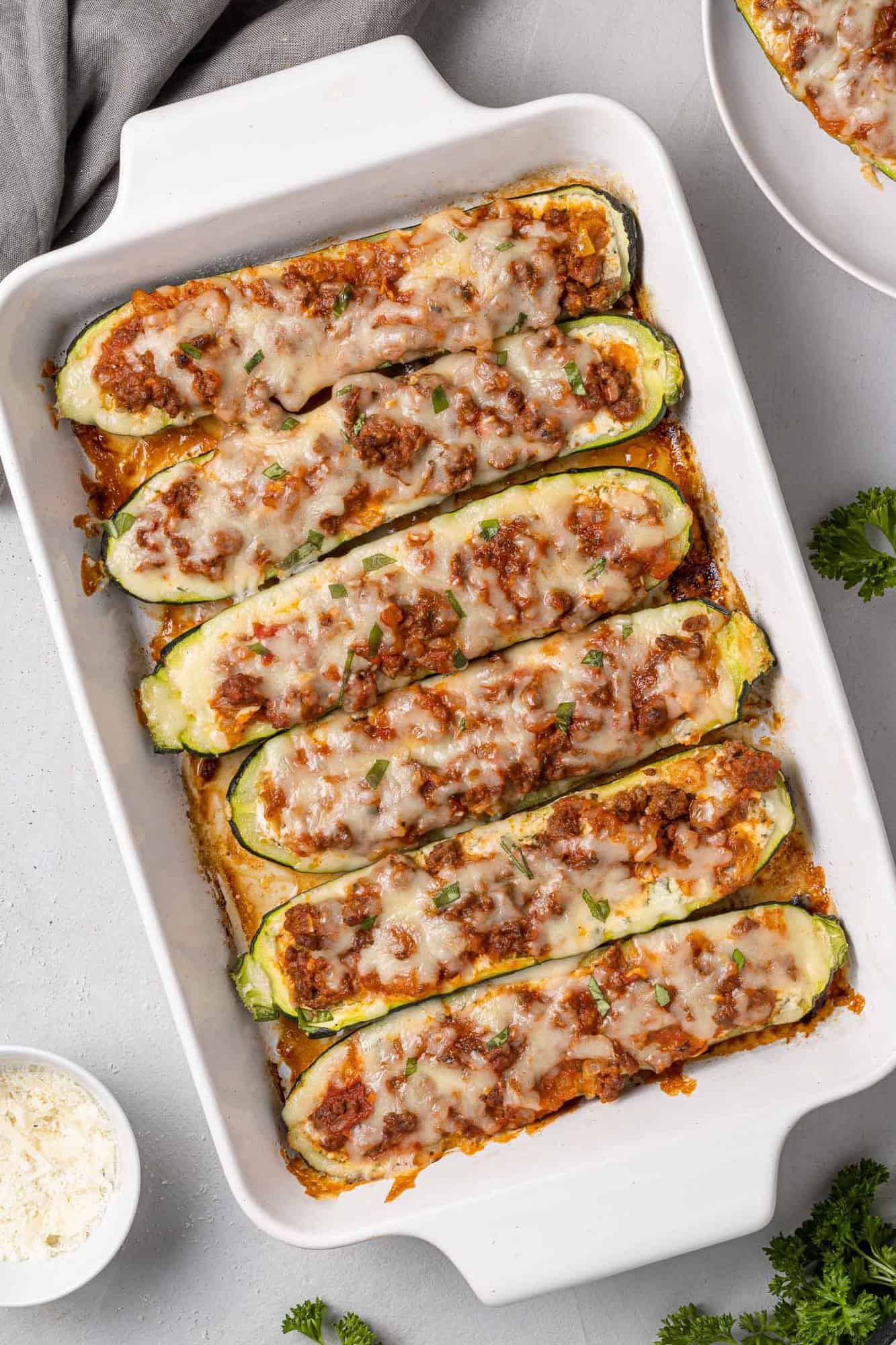 White baking dish with stuffed lasagna halves.