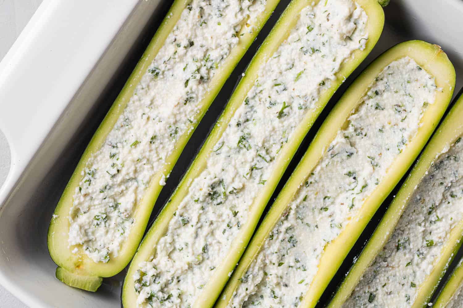 Zucchini halves stuffed with ricotta mixture.