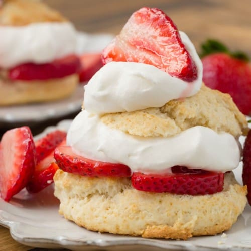 Layered strawberry shortcake on a white plate.