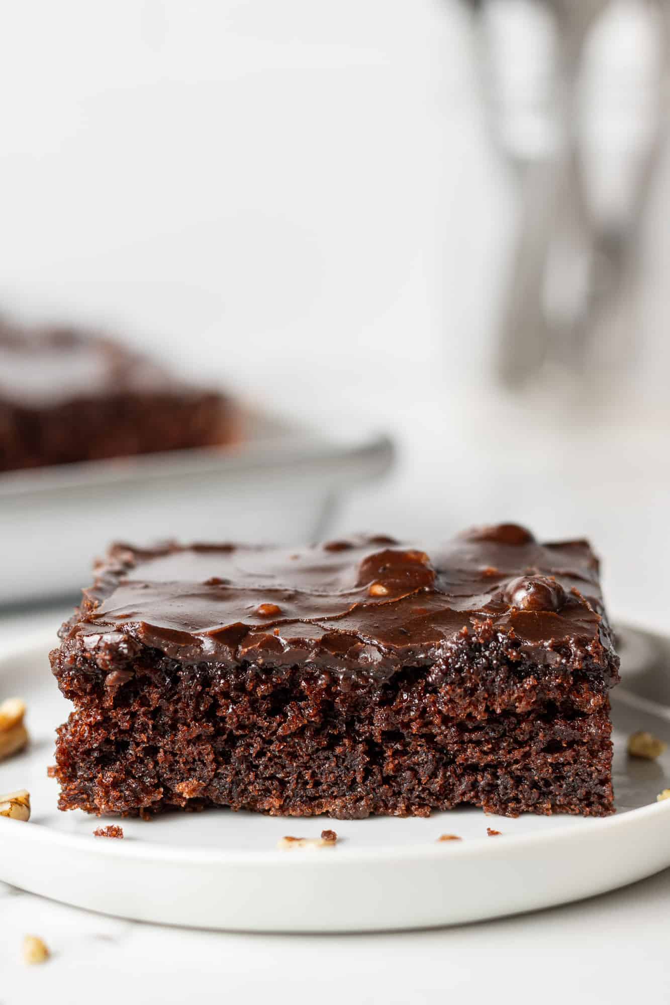 Slice of chocolate cake on a round white plate.