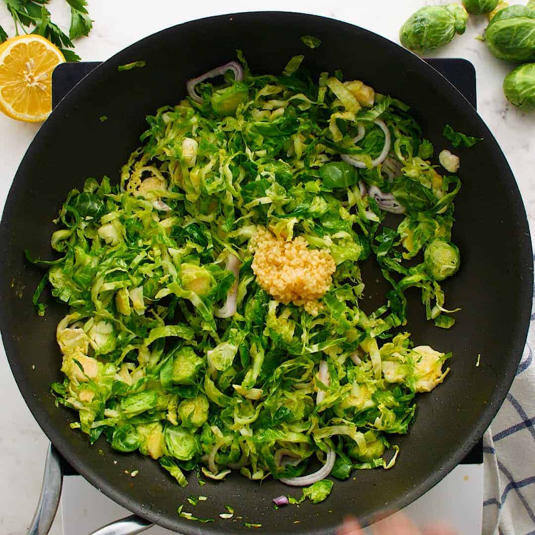 Garlic on top of sautéed Brussels sprouts.