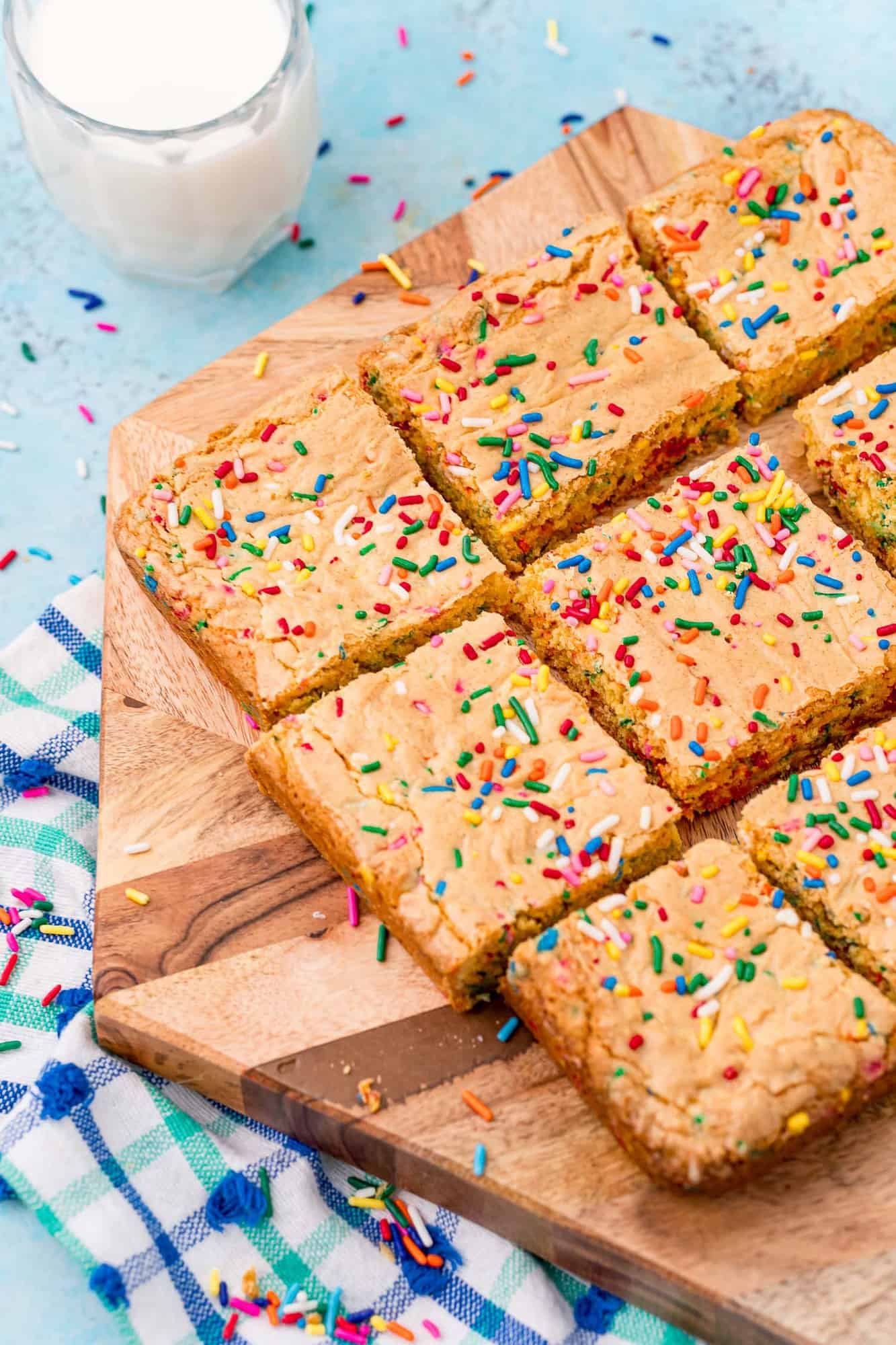 Cut blondies on a wooden cutting board.