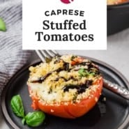 Tomato on a black plate, text overlay reads "caprese stuffed tomatoes."