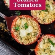 Tomato on a black plate, text overlay reads "caprese stuffed tomatoes."