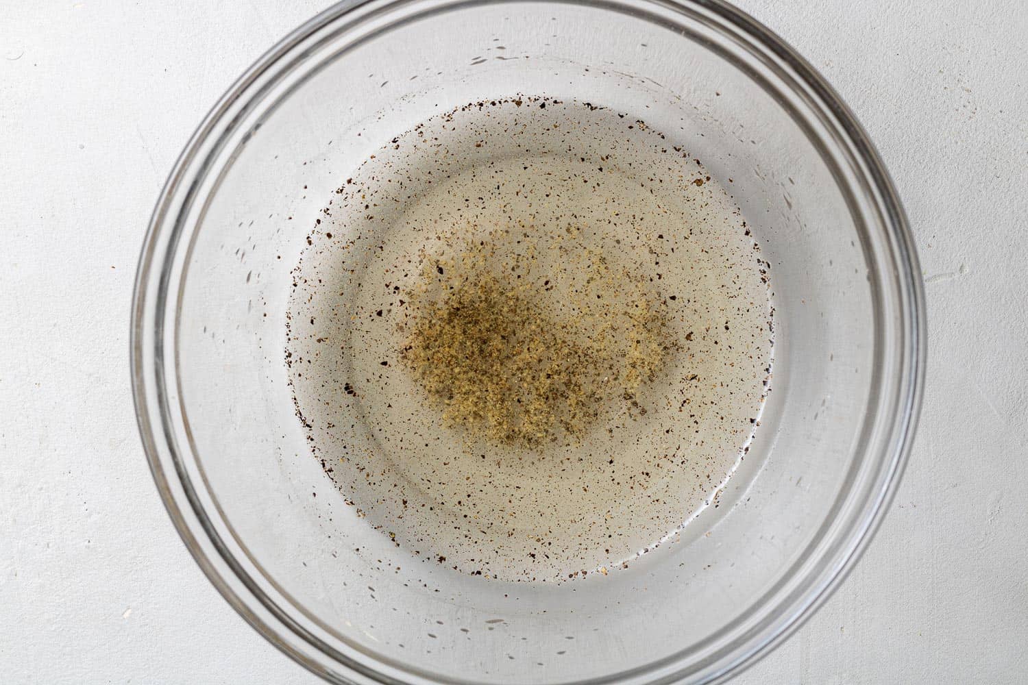 Dressing for cucumber salad in a small bowl.