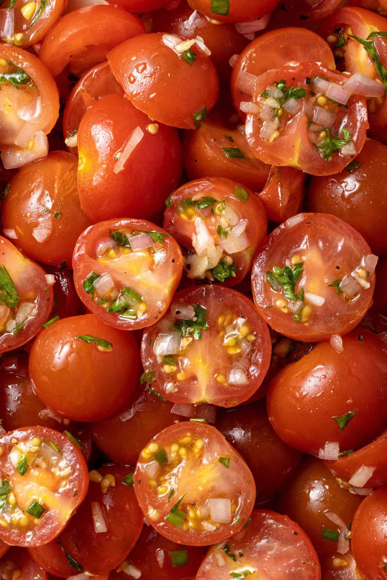 Close up of marinated tomatoes, filling image.