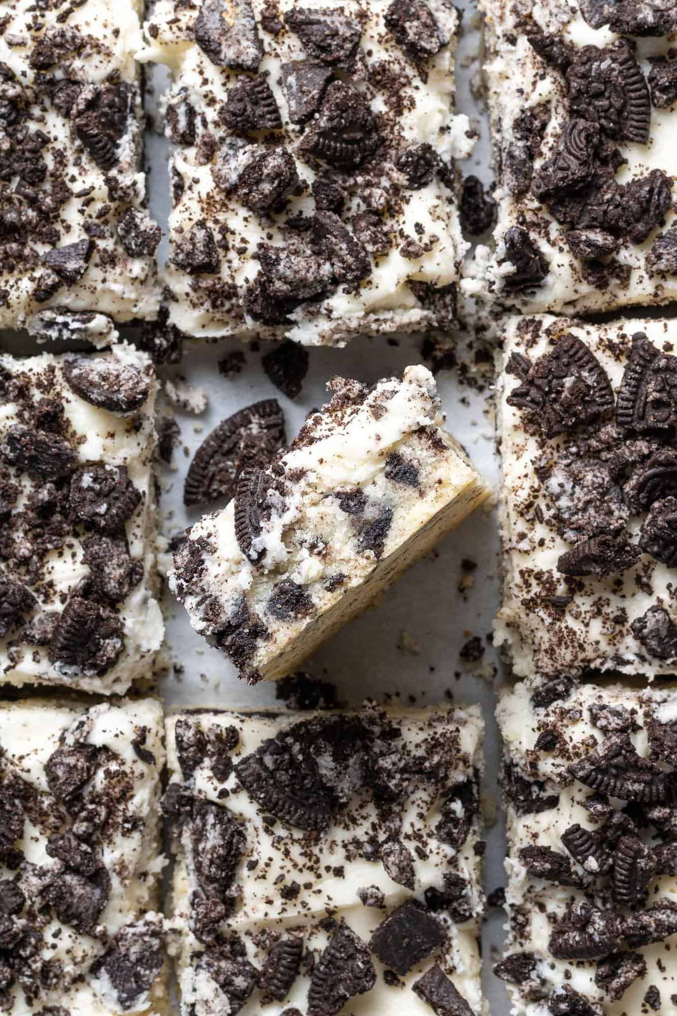 Cookie bars topped with oreos, one on its side to show layers.