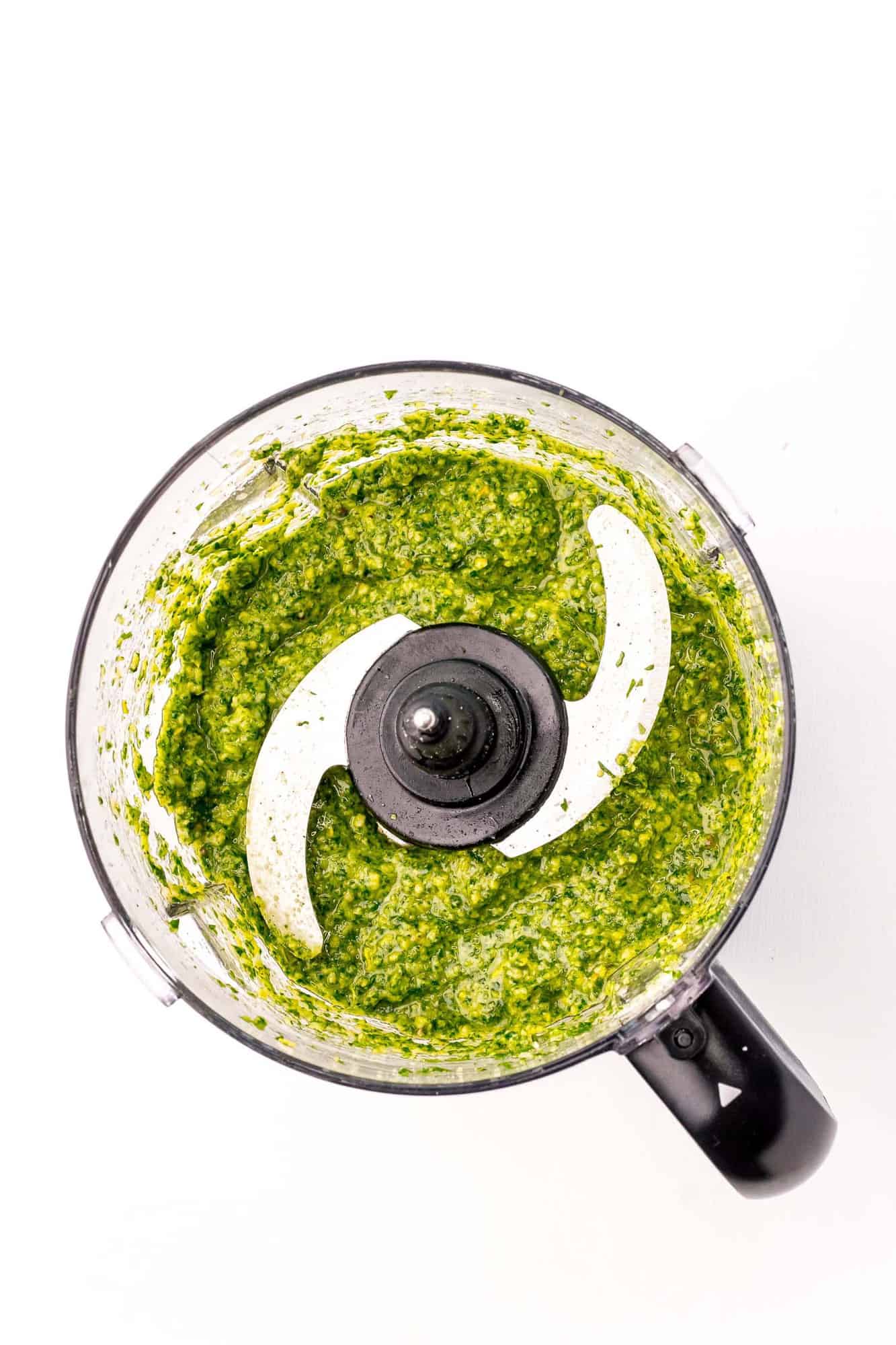 Pesto in a food processor, overhead view.